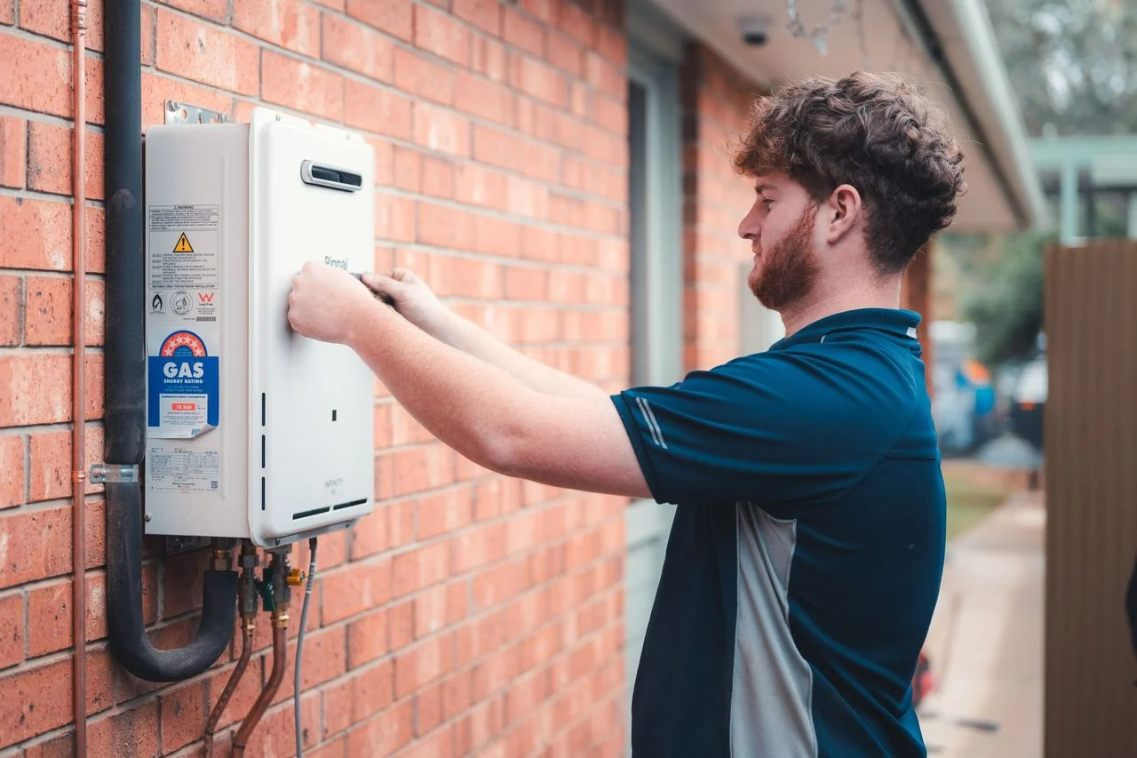 Grove plumber working on a Rinnai hot-water installation